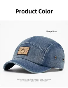 Detail of deep blue denim 5-panel baseball cap showing metal eyelets and brown patch
