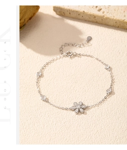 Detailed close-up of a silver flower bracelet with sparkling cubic zirconia accents
