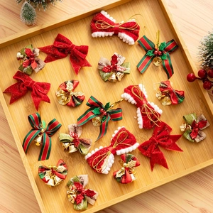 Close-up of festive Christmas bows with gold bells on a wooden tray for gift wrapping