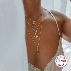Vintage 925 sterling silver gold plated irregular initial necklace worn by a model