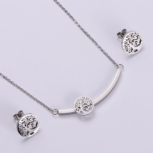 Detail view of silver stainless steel jewelry set featuring hollow Tree of Life patterns