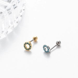 Detailed view of gold and silver circular cartilage studs with blue turquoise inlay