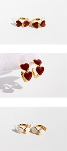 Detail view of vintage red and cream enamel heart earrings with gold textured C-shape frames