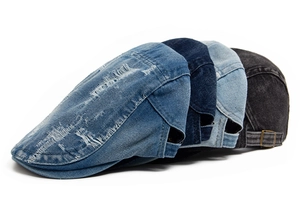 Detailed view of four vintage washed denim beret hats with distressed ripped accents