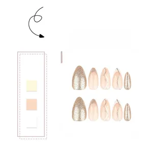 Detail of glitter gold almond press-on nails with minimalist wave line patterns