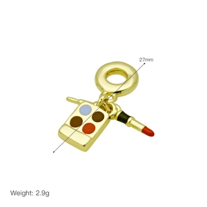 Detail of 27mm gold makeup charms showing lipstick and enamel palette, weight 2.9g