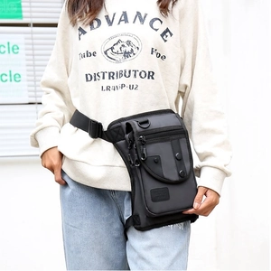 Tactical black tactical leg bag with multiple pockets worn on leg for outdoor hiking