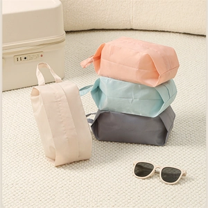 Detail of four colorful portable travel storage bags showing waterproof fabric and handles