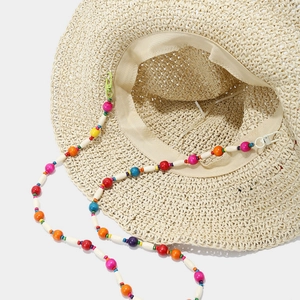 Chapeau de soleil en paille beige ajouré avec mentonnière en perles colorées
