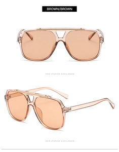 Detail view of double bridge aviator sunglasses with brown frames and gold metal trim