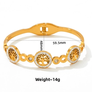 Detail of tree of life gold bangle with dimensions 59.5mm by 48mm in white background