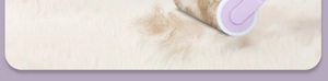 Detail of purple lint roller removing debris from white plush surface with sticky paper