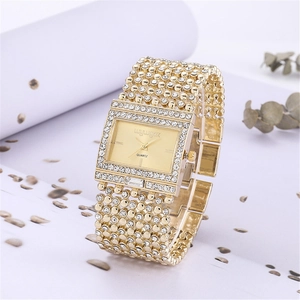Macro detail of luxury gold square quartz watch with pavé diamond finish and metal band