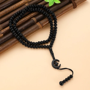 Detail of 99 black Muslim prayer beads with crescent star pendant and tassel decoration