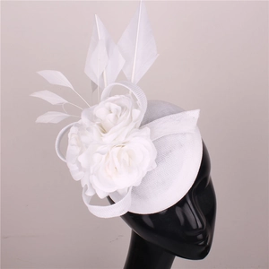 Elegant white fascinator hat with mesh floral design and feathers on a display model