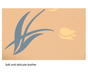 Detailed close-up of soft beige leather featuring blue leaves and yellow floral patterns