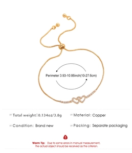 Detail of adjustable gold heart bracelet showing cubic zirconia inlay and 3.8g copper weight