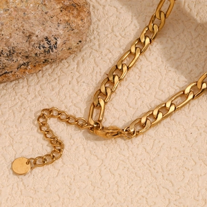 Close-up of 18K gold plated Figaro chain necklace with secure lobster clasp and extender