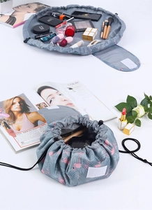 Detail view of water-resistant drawstring cosmetic bag with pink flamingo patterns