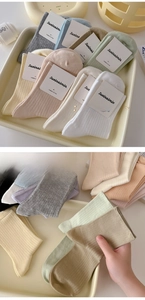 Detailed texture of combed cotton crew socks with vertical ribbed knit and soft pastel colors