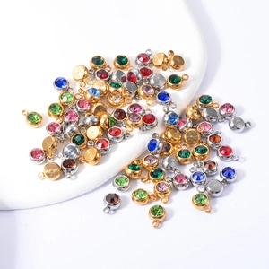 Macro shot of 6mm stainless steel round birthstone charms in gold and silver settings