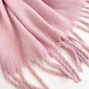 Close-up of pink mohair scarf showing soft fuzzy texture and elegant fringe details