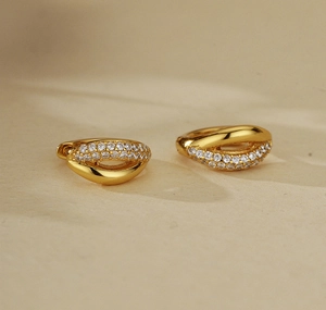 Close-up of gold-plated hoop earrings with micro-pave white cubic zirconia stones