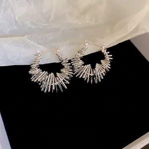 Modern minimalist irregular geometric hoop earrings in bright silver with sunburst texture