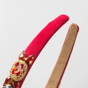 Elegant red fabric headband with vintage crystals and gold lace settings in side view