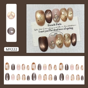 Brown cat eye press-on nails with champagne glitter and heart accents, 24 piece kit