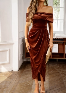 Detail of elegant off-shoulder velvet dress in caramel featuring waist-cinching and split hem