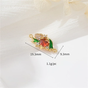 Macro detail of 14k gold berry charm with red zircon heart and dimensions 19.3x9.3mm