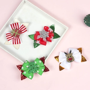 Detail of four Christmas hair clips with glitter ribbons on a pink background