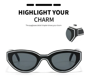 Detail view of cat eye sunglasses with black frames and contrasting white border accents