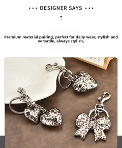 Detail of leopard print heart and bow metal keychains with high-quality lobster clasps
