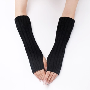 Close-up of black cable knit long fingerless gloves showing detailed woolen texture