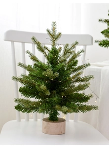 Detail of mini PE Christmas tree branch with tiny LED lights and a natural wood base