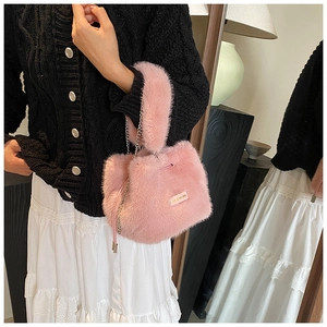 Detail of pink plush bucket bag with metal chain strap and 'love every day' engraved plate