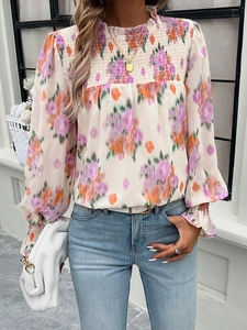 Close-up of smocked high neck and floral print on this elegant long sleeve blouse