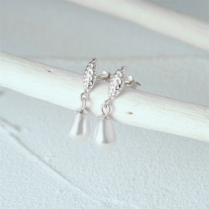 Detailed view of teardrop pearls on silver hooks with hammer leaf texture