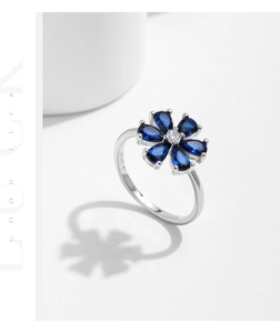 Macro shot of S925 sterling silver stamp on the inner band of blue flower ring