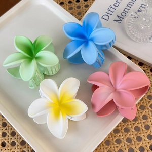 Frangipani flower hair claws in four colors for summer beach vacation hairstyles