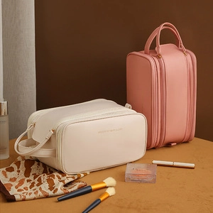 Chic stone-patterned makeup cases in beige and pink with handles and secure zippers