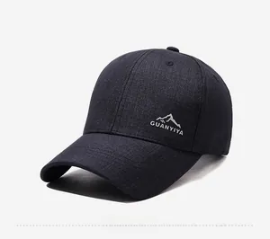 Side view detail of a navy blue baseball cap featuring silver mountain logo and text