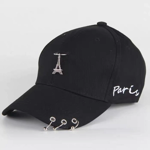 Detail of black baseball cap with Eiffel Tower metal pendant and Paris embroidery