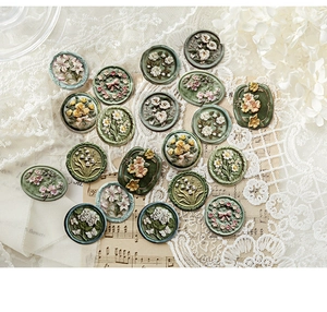 Macro view of vintage 3D embossed floral resin stickers on retro musical scores