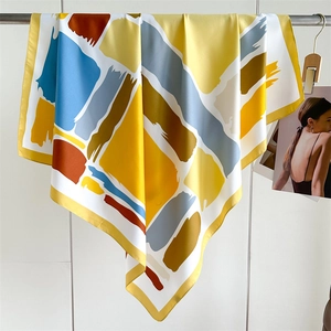 Luxury 90x90cm twill silk scarf with colorful geometric blocks shown in a full hanging view