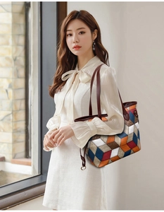 Detail of multi-color geometric patchwork tote bag with high-quality PU leather texture