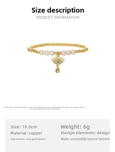 Detail of gold beaded bracelet with pearls and Evil Eye charm featuring blue stone