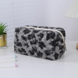 Close-up of leopard print plush makeup bag with soft texture and sturdy metal zipper